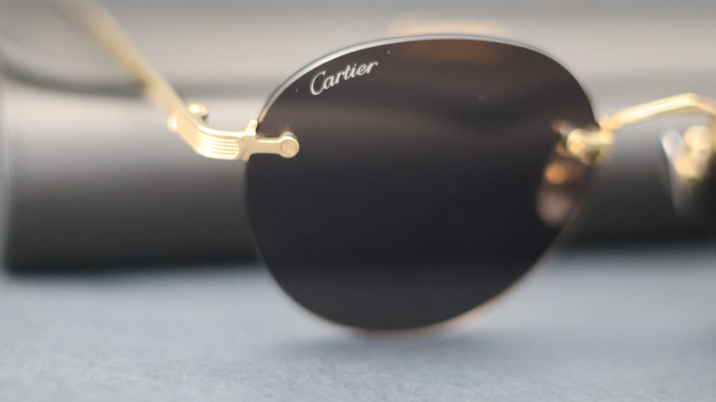 Cartier "CT0393S" Round Rimless Metal Glasses